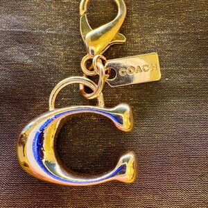 Gold keychain of letter C. Not authentic. Purse not for sale.